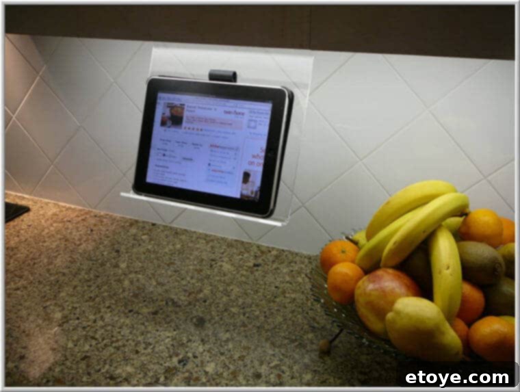 Kitchen iPad Stand Giveaway 2 Clear acrylic iPad rack mounted under a kitchen cabinet, showcasing a tablet for recipes
