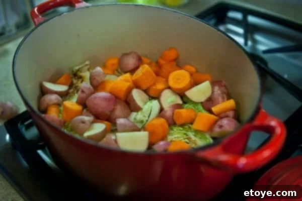 The Ultimate Guinness Corned Beef and Cabbage 17 carrots and potatoes in pot