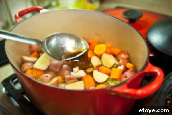 The Ultimate Guinness Corned Beef and Cabbage 18 pouring sauce on veg