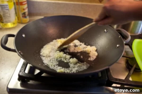Coastal Indian Fish Curry 7 Onion, ginger, and garlic simmering in a pan