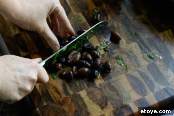 Fresh ingredients for Greek Mac and Cheese: spinach, olives, sun-dried tomatoes