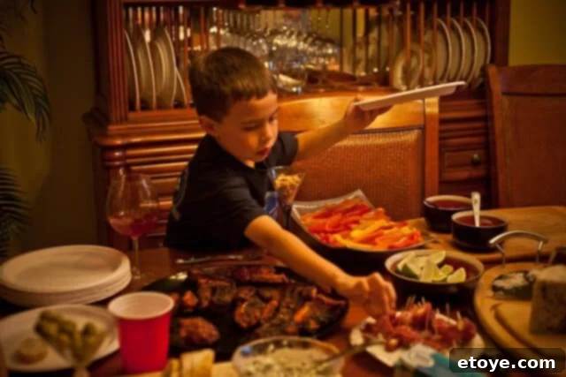 Flank Steak & Chèvre Toasts 9 A young boy, Andrew, happily eating Manchego cheese and Jamon Serrano, looking pleased after fishing.