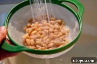 Hearty White Bean and Cabbage Stew 7 Canned cannellini beans, rinsed and drained, in a colander.