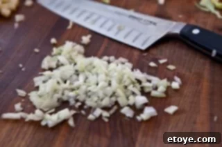 Hearty White Bean and Cabbage Stew 8 Finely minced onion, ready to be added to the dish.