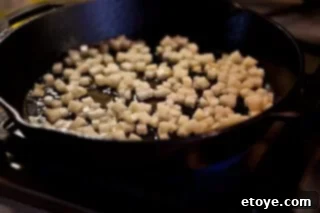 Hearty White Bean and Cabbage Stew 9 Diced potatoes sizzling in a hot skillet with olive oil, beginning to brown.