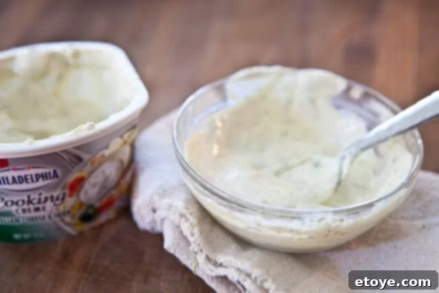 Plated prosciutto-wrapped asparagus with creamy sauce drizzled over