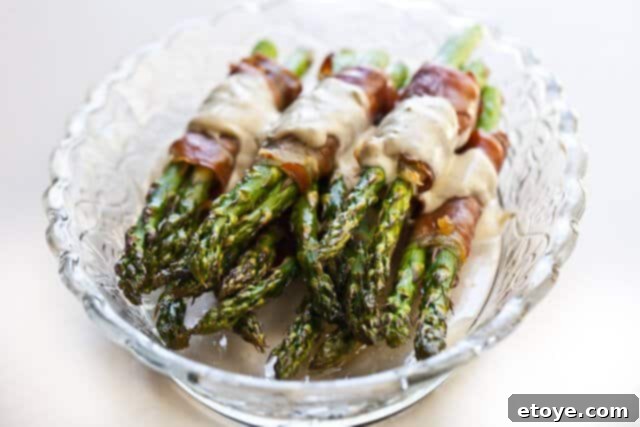 Close-up of asparagus bundles with a creamy drizzle