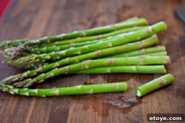 Wrapping asparagus spears with a slice of prosciutto