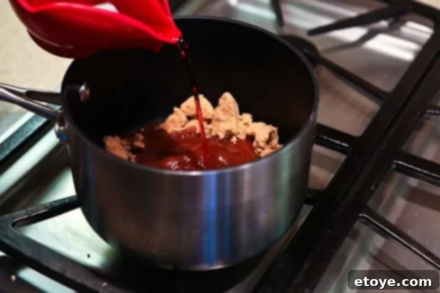 Sweet and Savory Cola Pineapple Glazed Ham 10 Cola and grape juice added to brown sugar in a saucepan for the glaze.