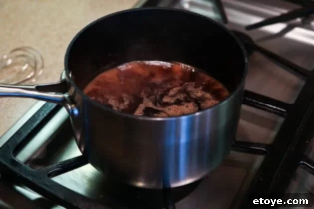 Sweet and Savory Cola Pineapple Glazed Ham 12 Simmering the cola and pineapple glaze until it thickens and becomes glossy.