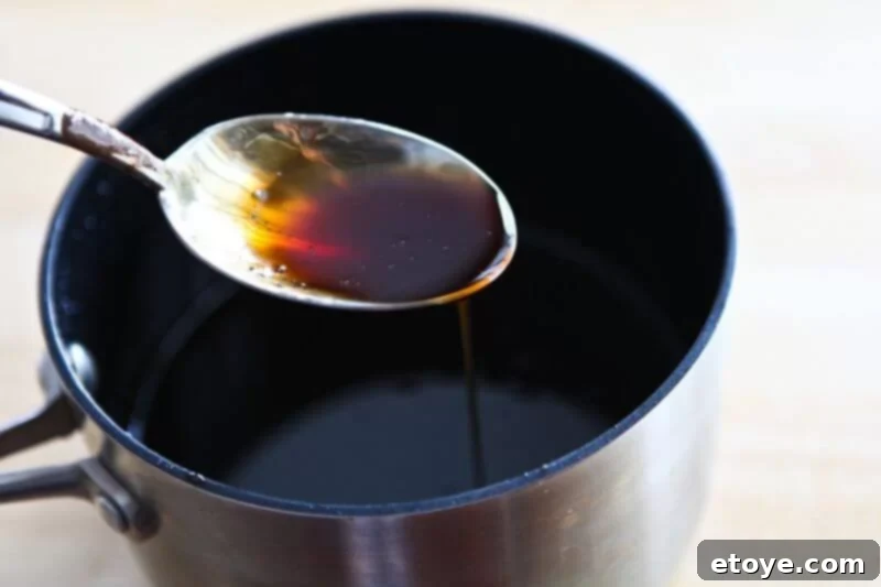 Sweet and Savory Cola Pineapple Glazed Ham 13 A spoon coated with the perfectly thickened and glossy cola glaze.