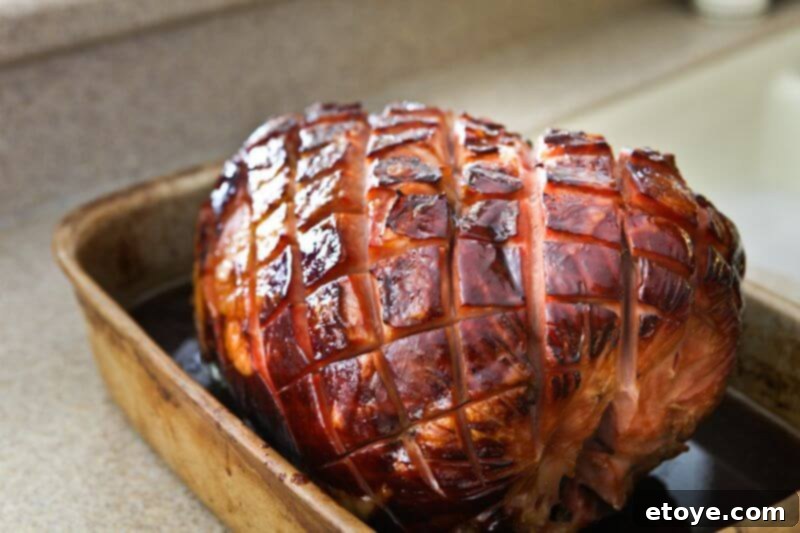 Sweet and Savory Cola Pineapple Glazed Ham 17 A beautifully caramelized and glazed ham in a roasting pan, ready to serve.