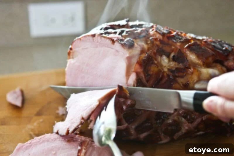 Sweet and Savory Cola Pineapple Glazed Ham 18 Expertly carving the perfectly cooked glazed ham.