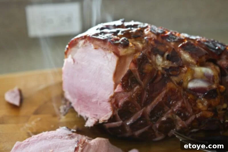 Sweet and Savory Cola Pineapple Glazed Ham 19 Close-up of perfectly sliced, moist glazed ham showing its tender texture.