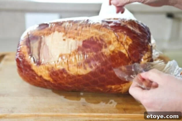 Sweet and Savory Cola Pineapple Glazed Ham 3 Removing packaging and membrane from ham before cooking.