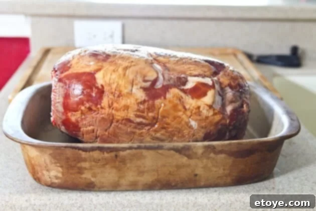 Sweet and Savory Cola Pineapple Glazed Ham 6 Placing the scored ham in a roasting pan for baking.