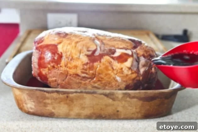 Sweet and Savory Cola Pineapple Glazed Ham 7 Pouring cola and grape juice into the roasting pan around the ham.