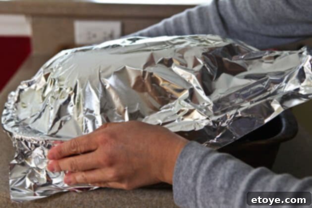 Sweet and Savory Cola Pineapple Glazed Ham 8 Covering the ham tightly with aluminum foil for slow roasting.