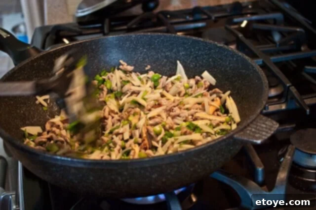 Savory Nian Gao Stir-Fry 12 Seasoning the stir-fry with a splash of soy sauce.