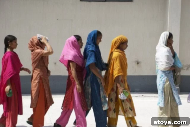 Mastering the Craft of Tea Appreciation 20 Colorful saris wait in line in India.