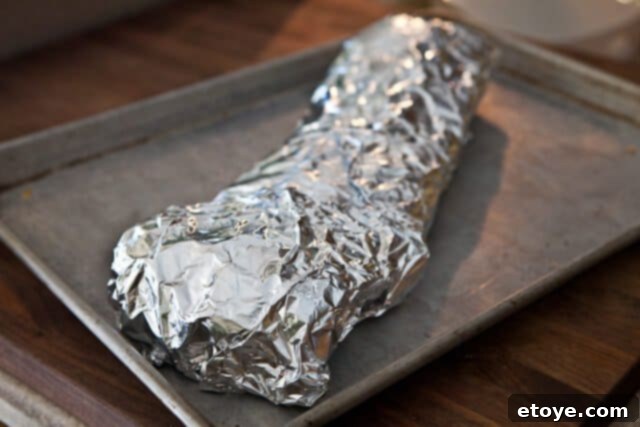 Cayenne Cinnamon Maple Ribs 8 Foil-wrapped ribs baking in the oven