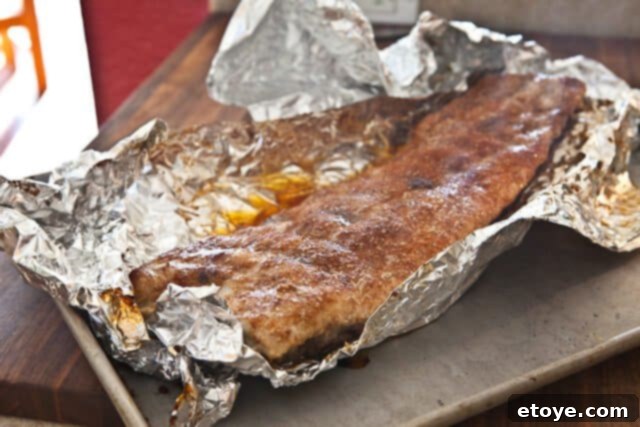 Cayenne Cinnamon Maple Ribs 9 Unwrapping baked ribs from foil