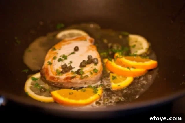 Fish with Citrus Caper Sauce Ready to Serve Finished pan-seared fish with citrus caper sauce and fresh parsley