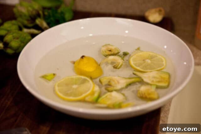 Baby artichoke slices soaking in lemon water.