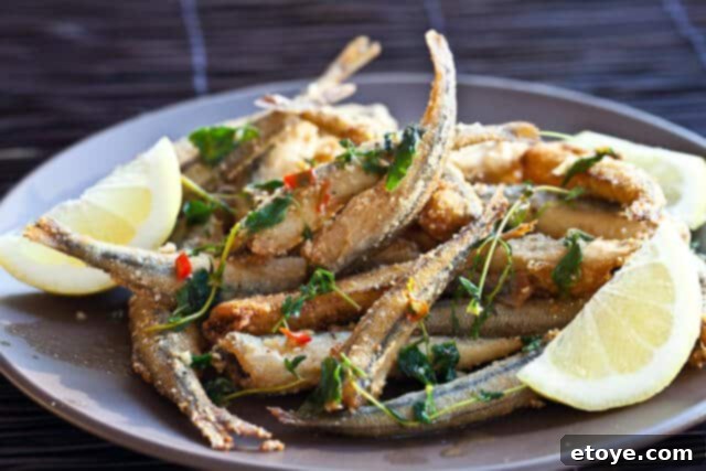 Crispy Fried Smelt Recipe Delicious Crispy Pan-Fried Smelt, served with fresh herbs and lemon wedges