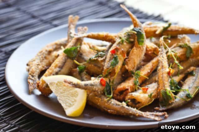 Golden Fried Smelt 11 Close-up of the final dish: crispy fried smelt with lemon, herbs, and chili