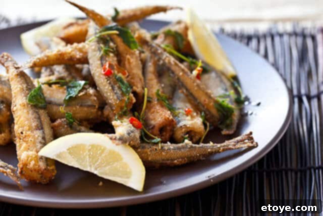 Golden Fried Smelt 2 Fresh smelt fish on a white plate, ready for preparation