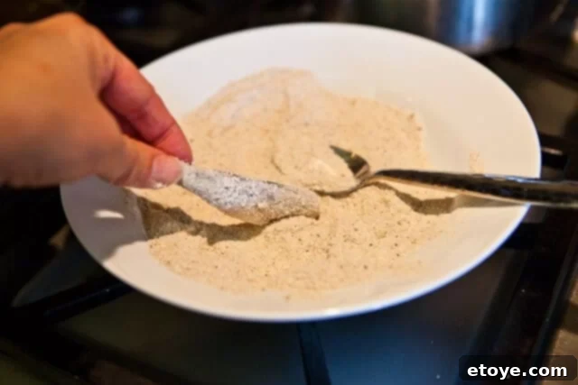 Golden Fried Smelt 4 Smelt fish frying in hot oil in a pan, turning golden brown