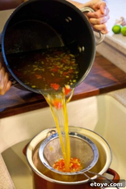 Straining the broth base Straining the Bouillabaisse broth into a clean pot