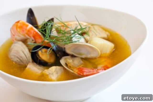 Fresh seafood and Bouillabaisse base Bouillabaisse soup base and fresh seafood ingredients laid out
