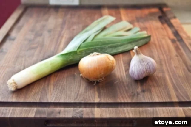 Sautéing aromatics Sautéing leek, onion, and garlic in olive oil for Bouillabaisse