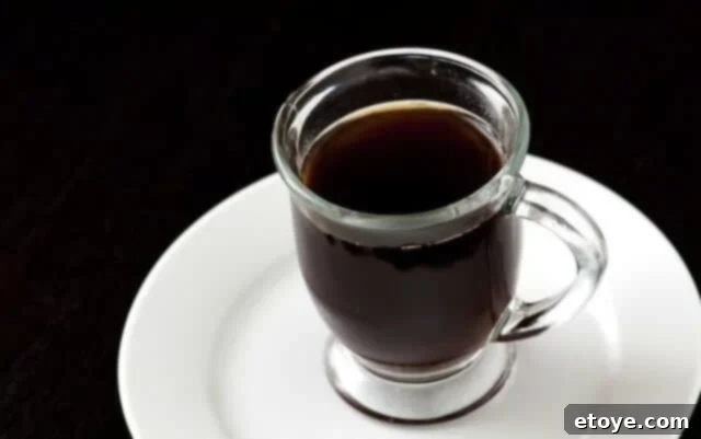 Chocolate and Coffee Cupcakes with Coconut Frosting Coffee Rich chocolate coffee cupcake batter being poured into cupcake liners, showcasing the key ingredient: strong brewed coffee.