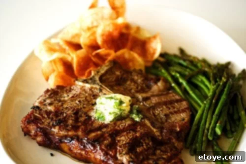 Grilled steak with garlic-herb butter and a side of fries