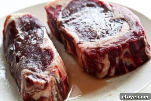 Steak after 1.25 hours of salting, still showing surface moisture and salt