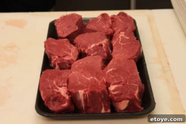Various leftover scraps from trimming a beef tenderloin, including fat and small pieces