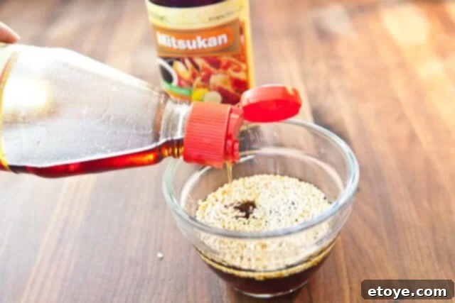 Citrus Ponzu Cabbage Crunch 10 Sesame oil and sesame seeds being added to the ponzu sauce