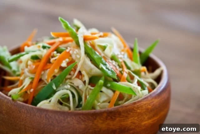 Citrus Ponzu Cabbage Crunch 2 Close-up of fresh snow peas and carrots, prepped for Asian slaw