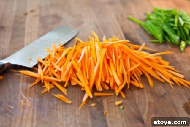 Citrus Ponzu Cabbage Crunch 4 Carrots being finely sliced into matchsticks for the slaw