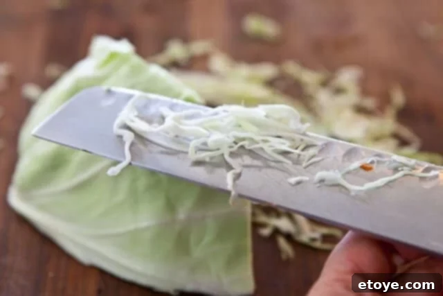 Citrus Ponzu Cabbage Crunch 6 Hand shredding cabbage with a sharp knife for the slaw