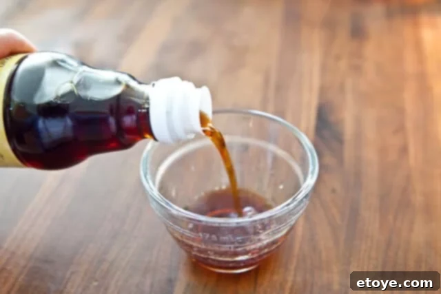 Citrus Ponzu Cabbage Crunch 9 Pouring ponzu sauce into a mixing bowl