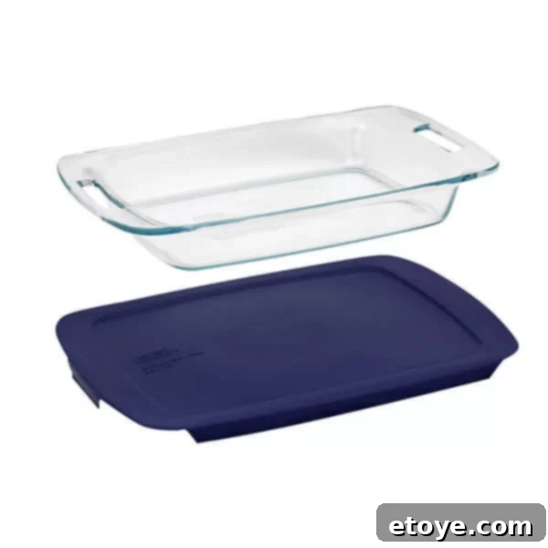 Pyrex Easy Grab 3-quart baking dish with blue plastic lid on a kitchen counter