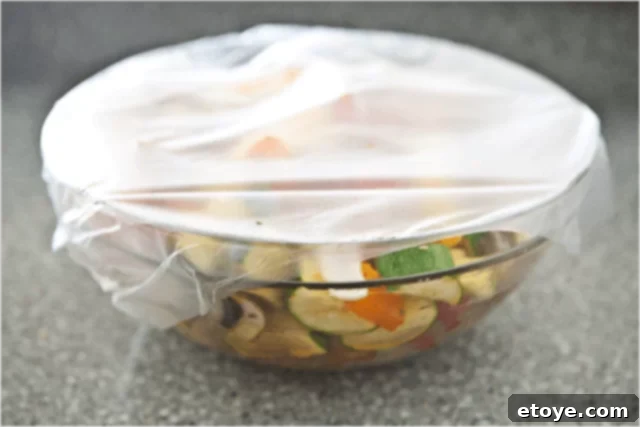 Covered bowls of marinating kabob ingredients