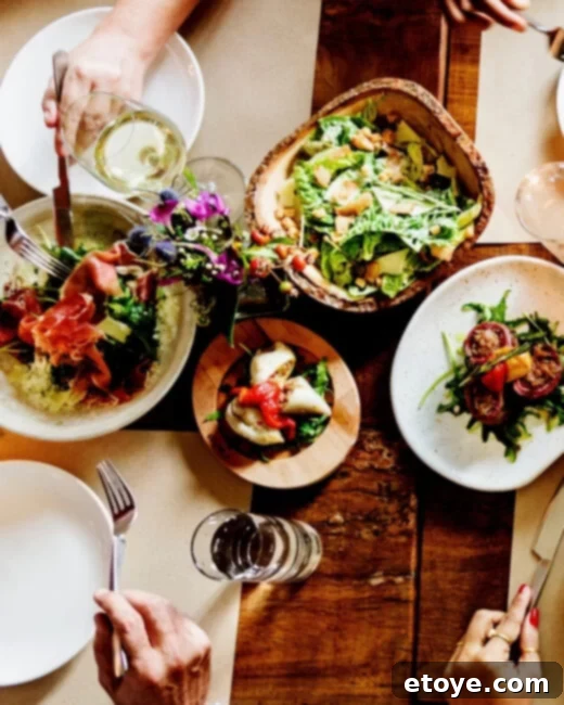 A beautifully set dinner table with homemade food, ready to be shared with friends.