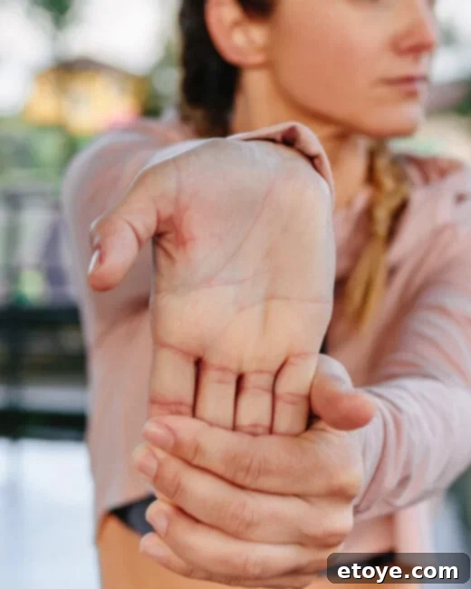 Hand Pain Relief Massager Giveaway 5 Person stretching their wrist to relieve hand pain