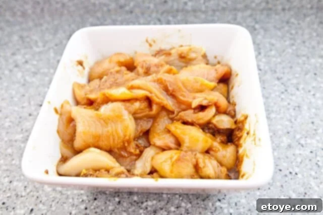 Savory Peanut Chicken Skewers 6 Chicken marinating in a bowl