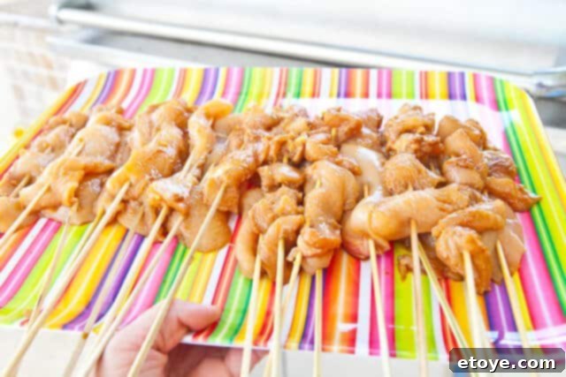 Savory Peanut Chicken Skewers 8 Chicken satay grilling on a barbecue